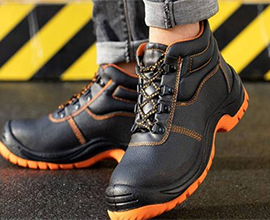 Heavy-duty black safety shoes with orange sole by Safety Shoes Manufacturer – DSK Safety